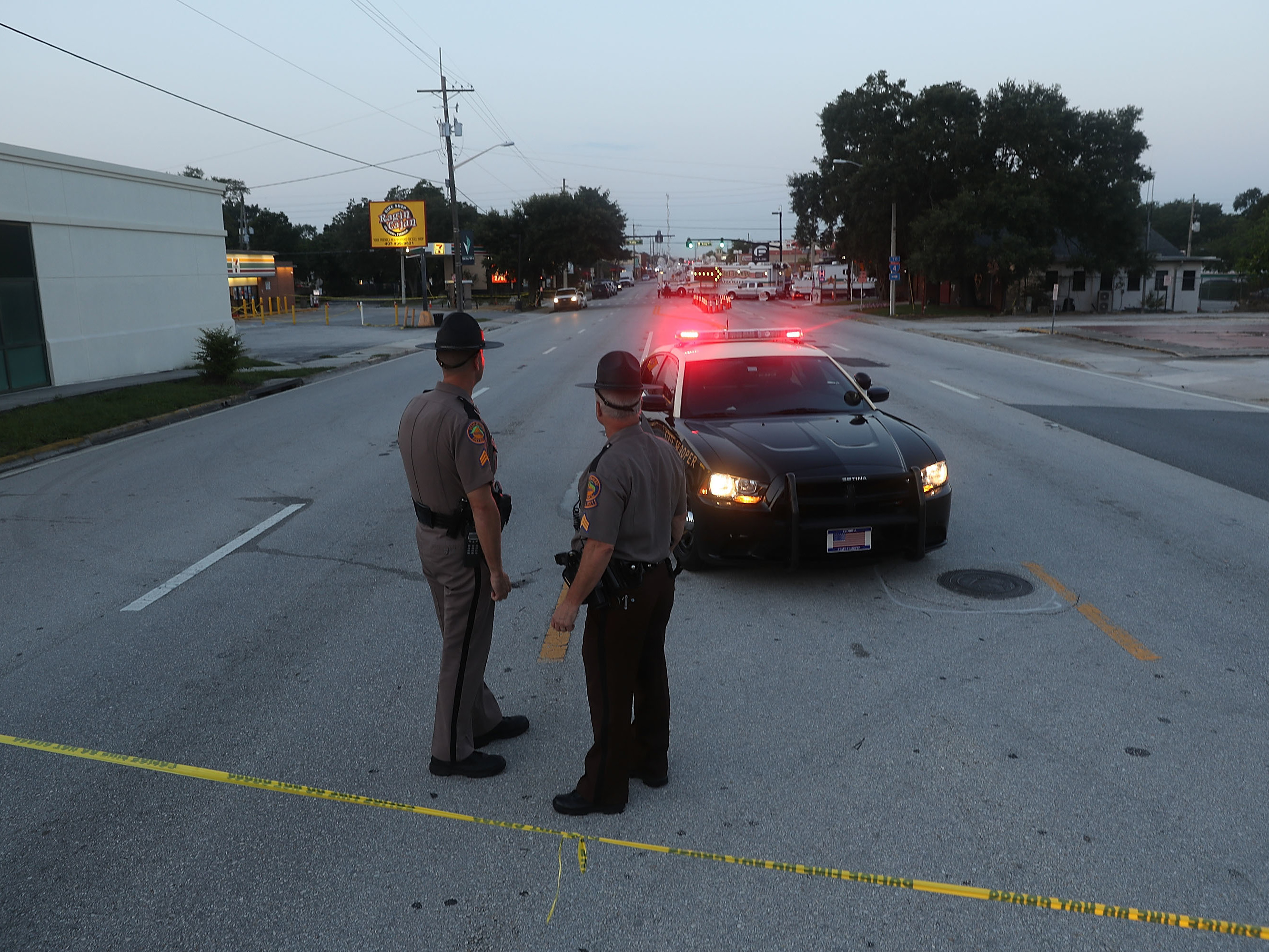 Law enforcement officials block off the road near Pulse nightclub on June 15 as they continue the investigation into the shooting there. The Justice Department on Monday released a transcript of a 911 call that Omar Mateen made the night of the shooting.