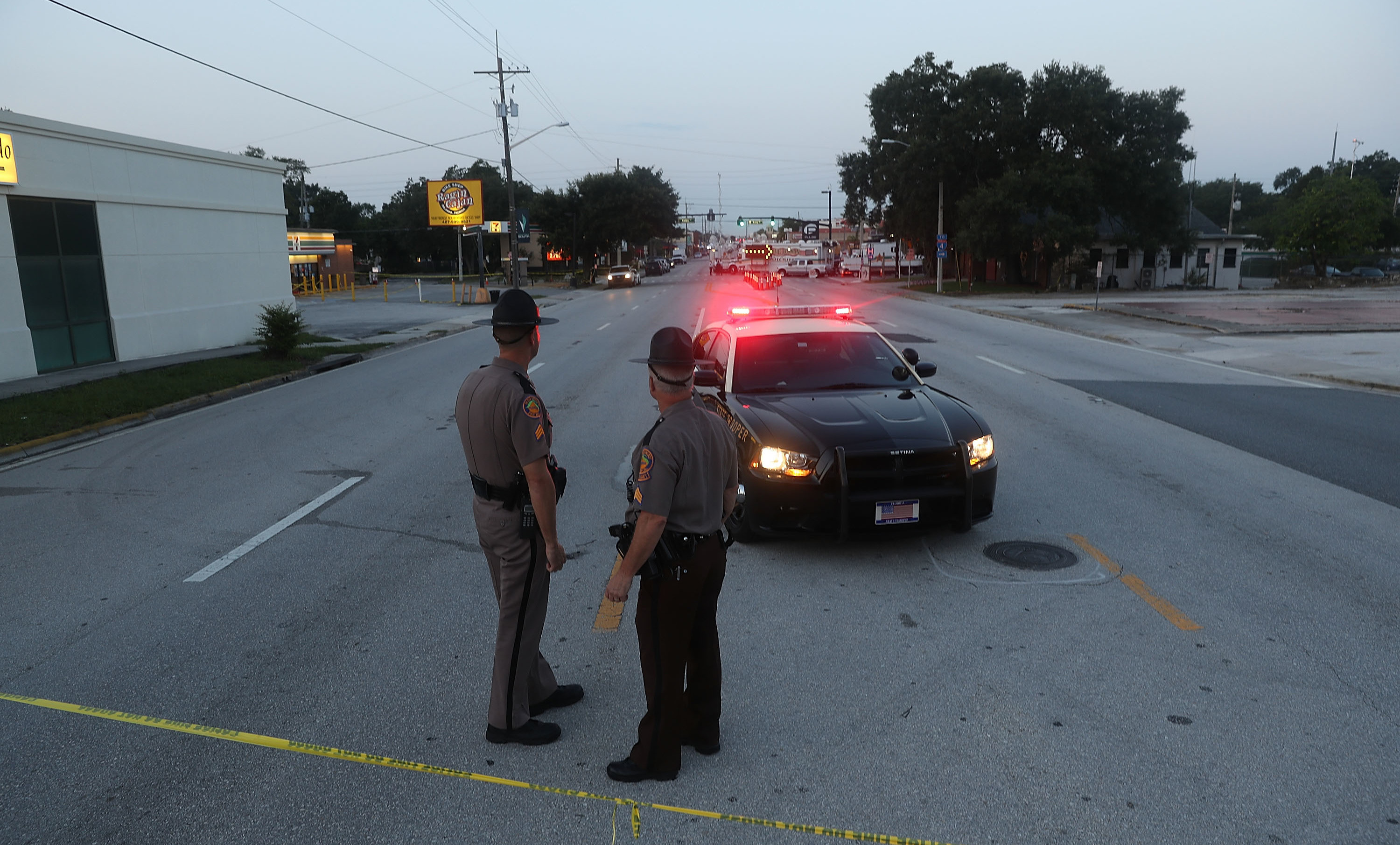 Law enforcement officials block off the road near Pulse nightclub on June 15 as they continue the investigation into the shooting there. The Justice Department on Monday released a transcript of a 911 call that Omar Mateen made the night of the shooting.