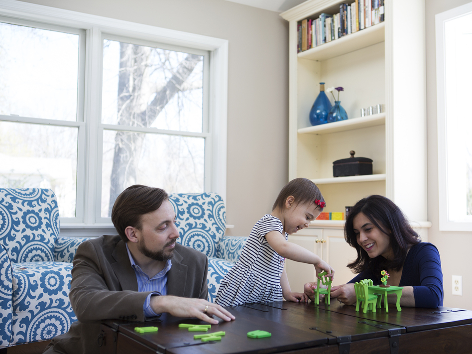 Travis and Sadiye Rieder play with Sinem in their home. They've agreed that if they want more children, they'll adopt.
