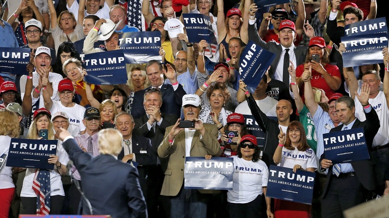 Donald Trump points to a roaring crowd of supporters during a speech Saturday in Phoenix, Ariz. (Ross D. Franklin/AP)