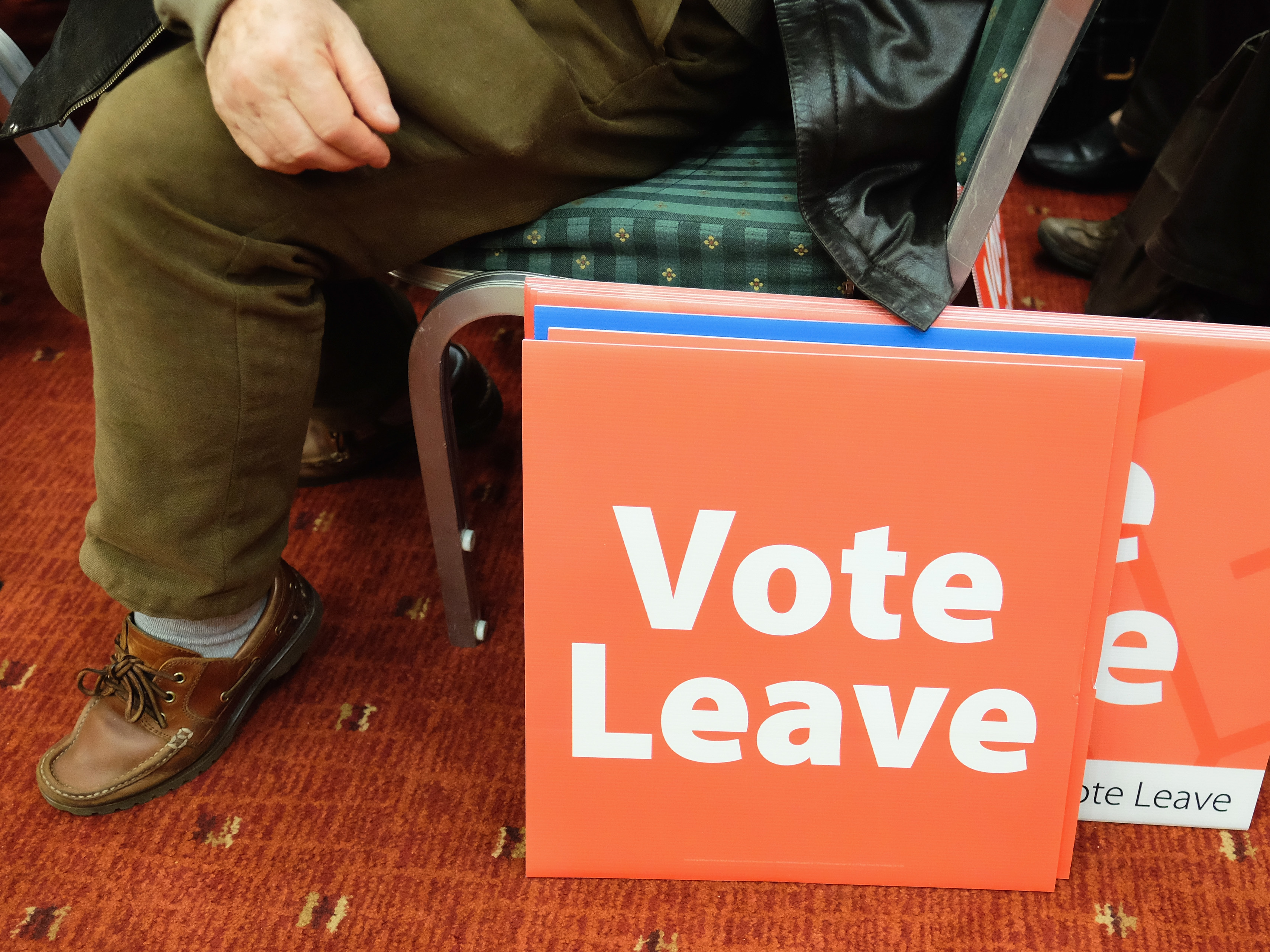 A man sits next to campaign posters in Newcastle upon Tyne, England, in April. On June 23, the United Kingdom voted to leave the European Union. What comes next? (Photo by Ian Forsyth/Getty Images)