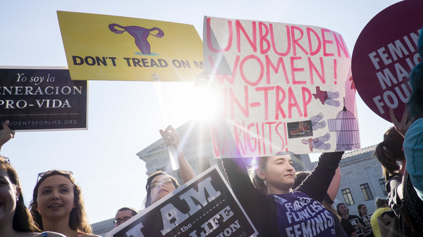 Abortion rights supporters and opponents wait for rulings in front of the U.S. Supreme Court on Monday in Washington, D.C.