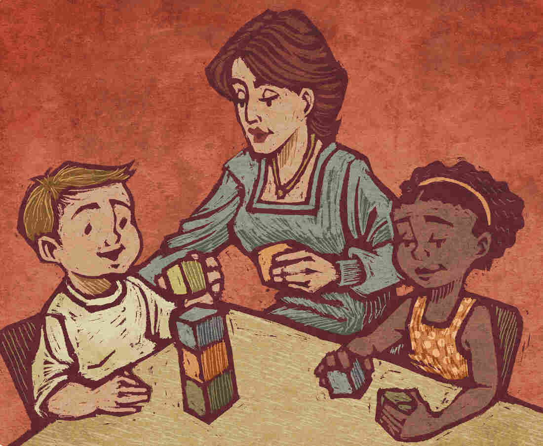 A teacher and two students play with blocks