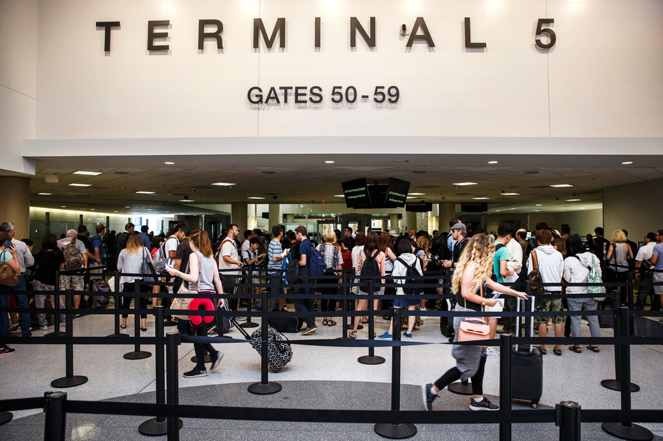 Passengers walk through a TSA checkpoint area at Los Angeles International Airport. Security experts say making airports safer is a huge challenge because public areas are designed for commerce.