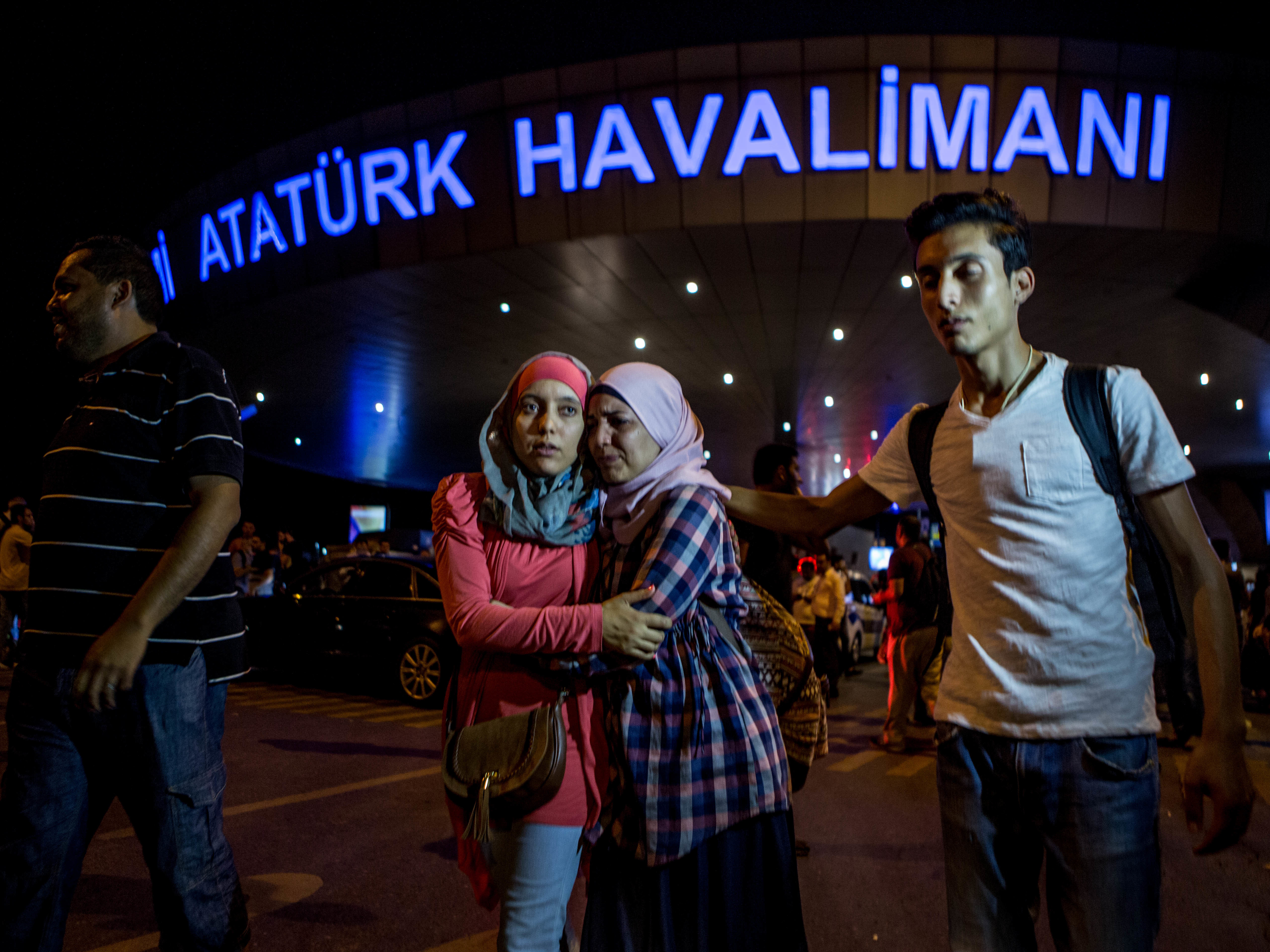 Passengers leave Istanbul Ataturk, Turkey's largest airport, after a suicide bomb attack Tuesday killed at least 42 people and wounded more than 230 people.
