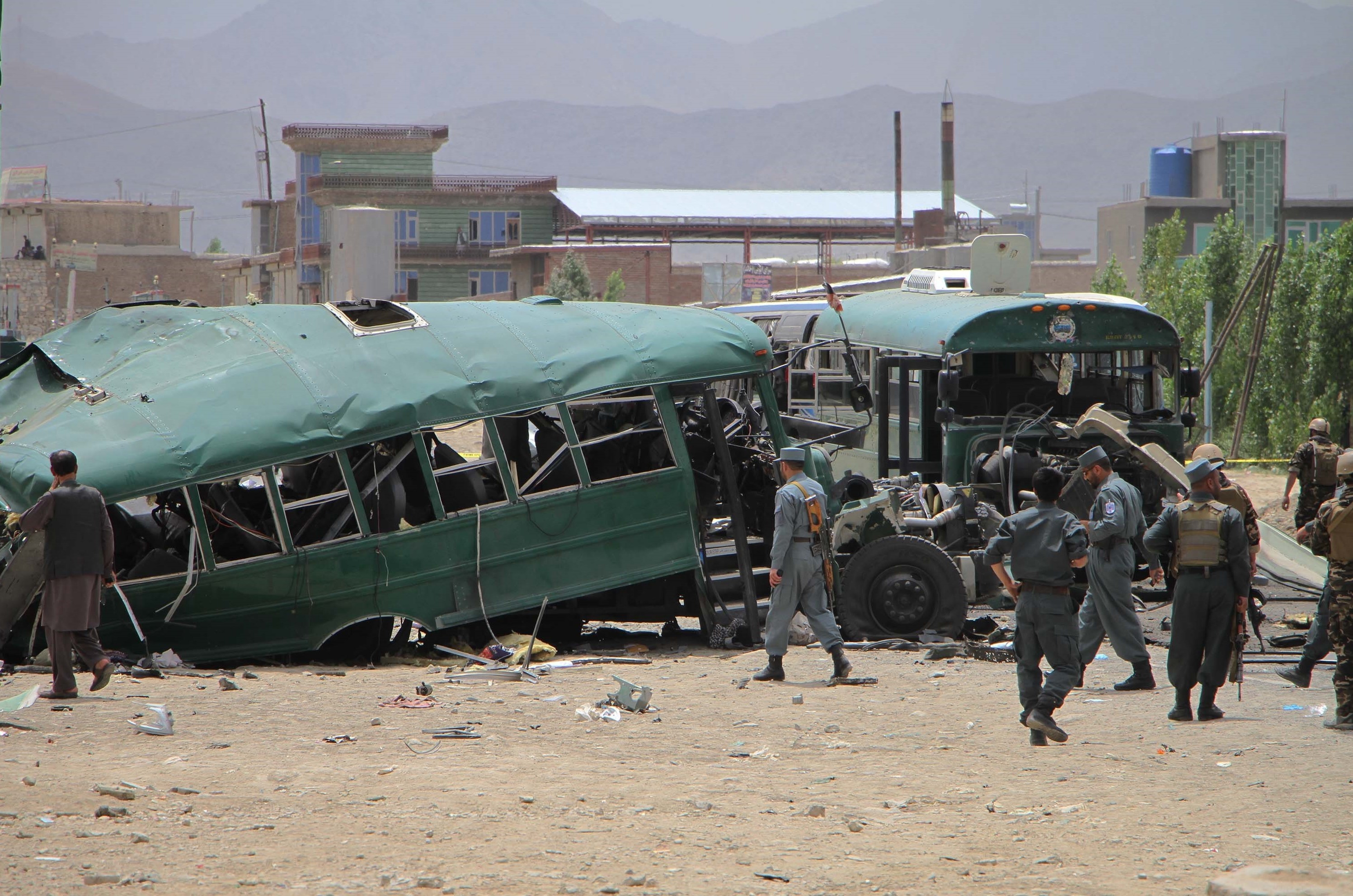 Afghan police inspect the site in in Kabul, Afghanistan, where a bus convoy was attacked on Thursday. The buses carrying police cadets were targeted as they were on their way from the neighboring Maidan Wardak province to Kabul. (Getty Images)