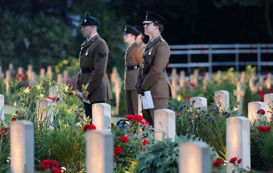 British soldiers stand among graves as they attend a vigil Thursday to commemorate the 100th anniversary of the beginning of the Battle of the Somme in northern France. (Francois Mori/AP)