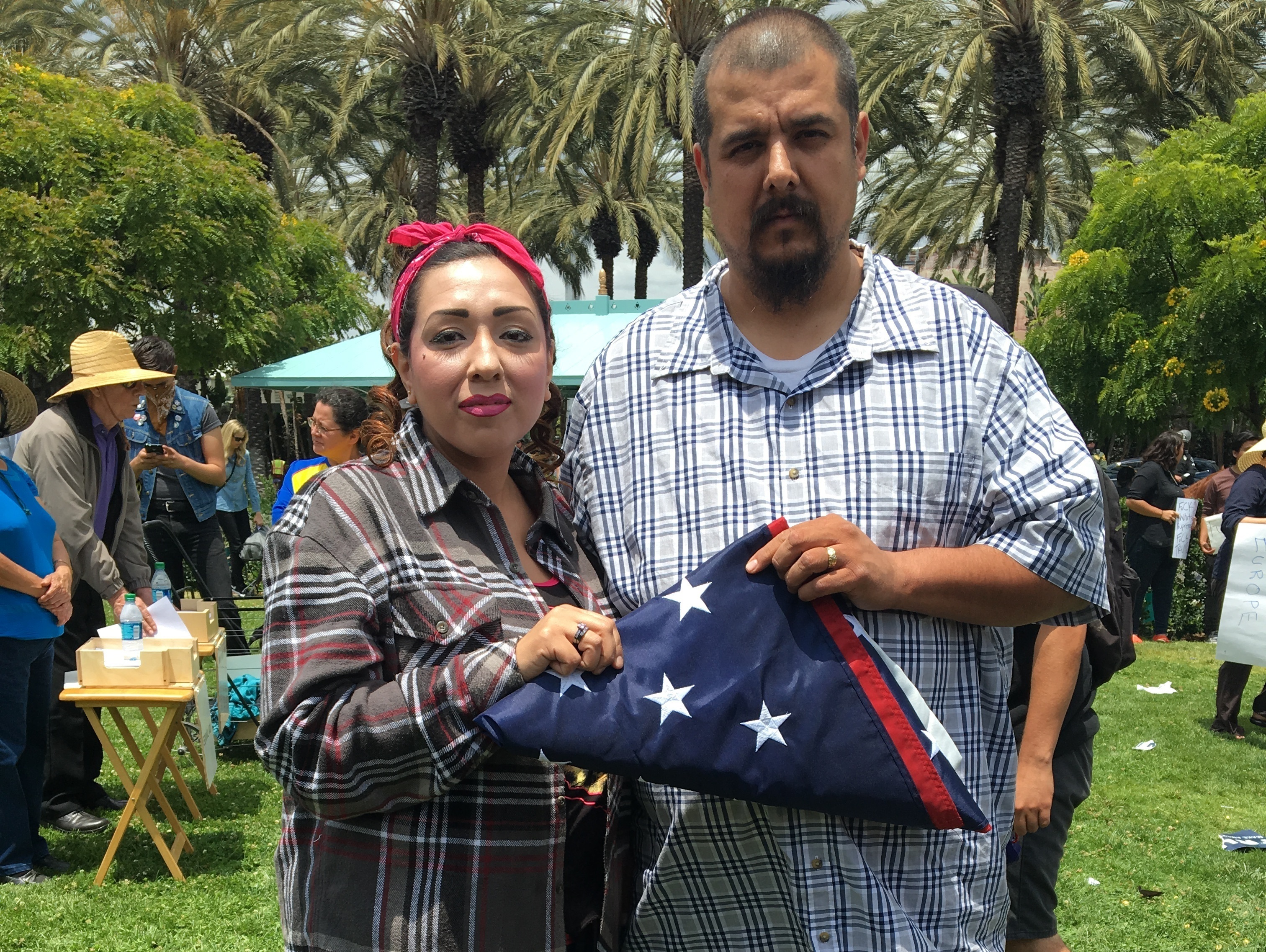 At a recent anti-Donald Trump protest in Anaheim, California, this couple said they saved the U.S. flag from a Trump supporter who was trying to get Latinos to trample it. Nervous about giving their full names, he said his was Anthony, and she said she was going by &quot;America.&quot; (Adrian Florido/NPR)