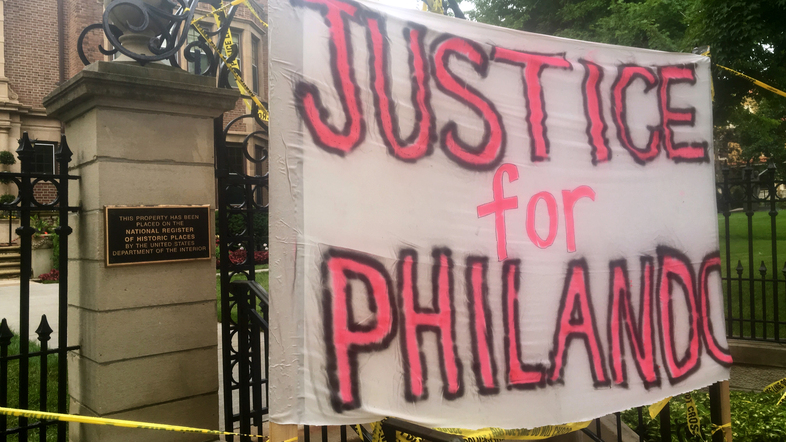 A sign is hung outside the Minnesota Governor's Residence as about 200 people gathered in St. Paul on Thursday, protesting the fatal shooting of Philando Castile by a suburban police officer. (Jeff Baenen/AP)
