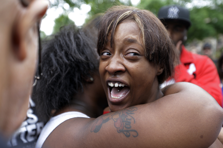 Diamond Reynolds, the girlfriend of Philando Castile, is consoled as she talks about his shooting death with protesters and media outside the governor's residence in St. Paul, Minn. (Jim Mone/AP)