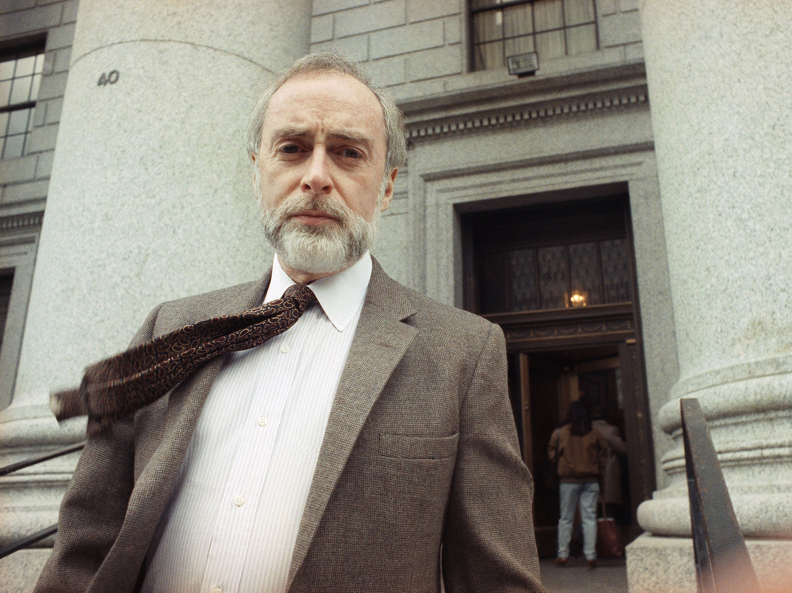 Journalist Sydney Schanberg poses for photographers after speaking to reporters in New York in 1991.
