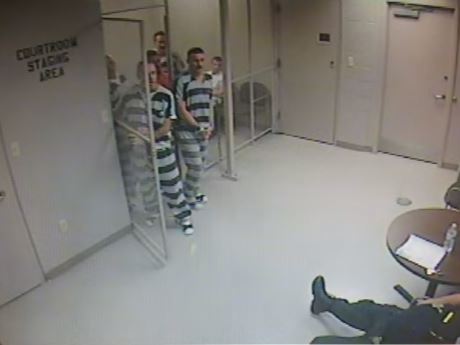 Surveillance video released by The Associated Press show inmates breaking out of their cell to assist a guard in distress.