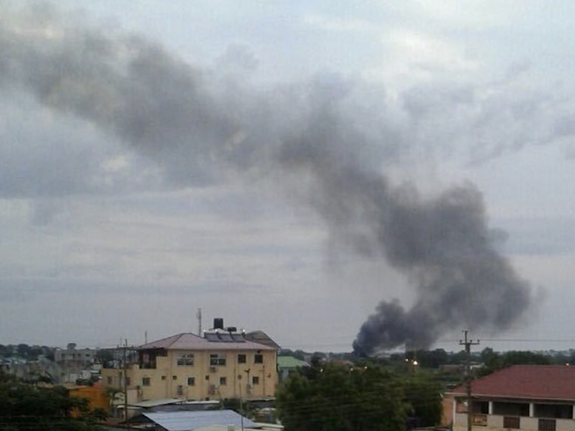 Black smoke rises above Juba, the capital of South Sudan, on Sunday. Explosions and heavy weapons gunfire are shaking Juba Monday in the fifth day of clashes between government and opposition forces, raising the specter of a return to civil war.