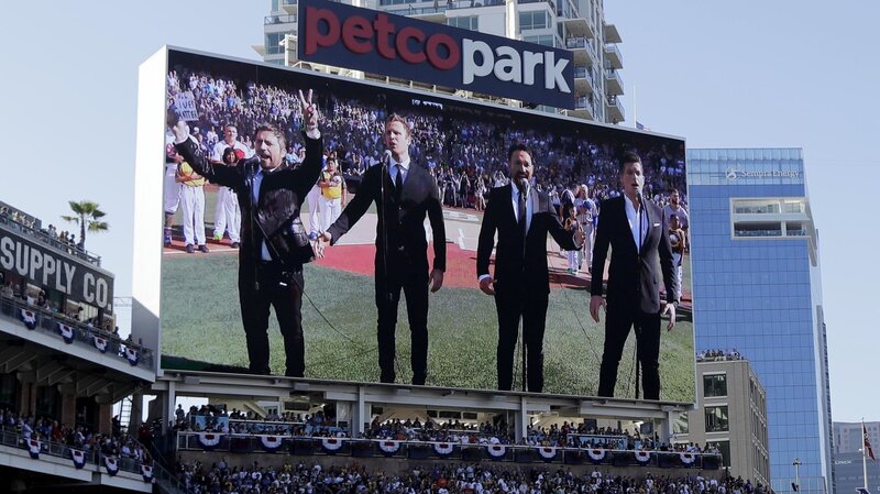 The Tenors, shown on the scoreboard, perform the Canadian national anthem prior to the MLB baseball All-Star Game on Tuesday.