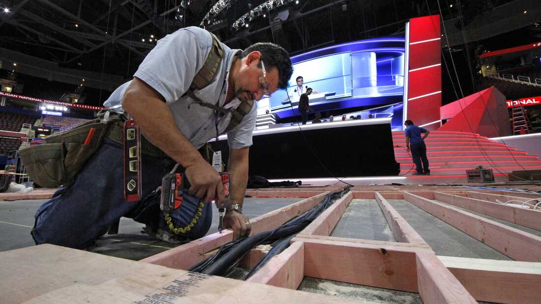 Carpenter Bill Kaim of Cleveland, works on the convention floor at the Quicken Loans Arena in downtown Cleveland, Ohio, in preparation for the upcoming Republican National Convention Wednesday, July 13, 2016. (AP Photo/Gene J. Puskar)