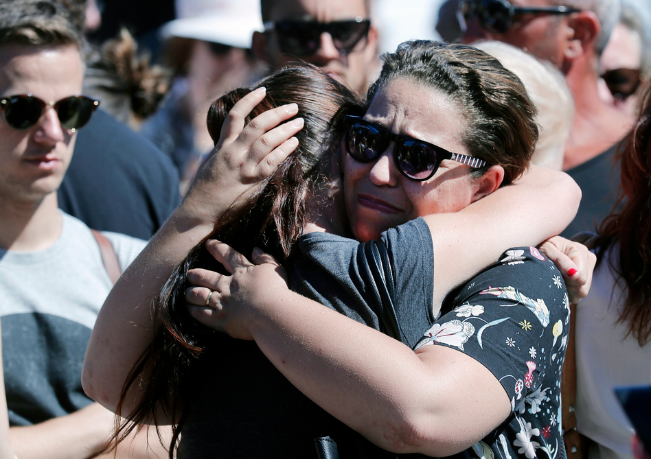 Women react near the scene of Thursday evening's attack in Nice. (Francois Mori/AP)