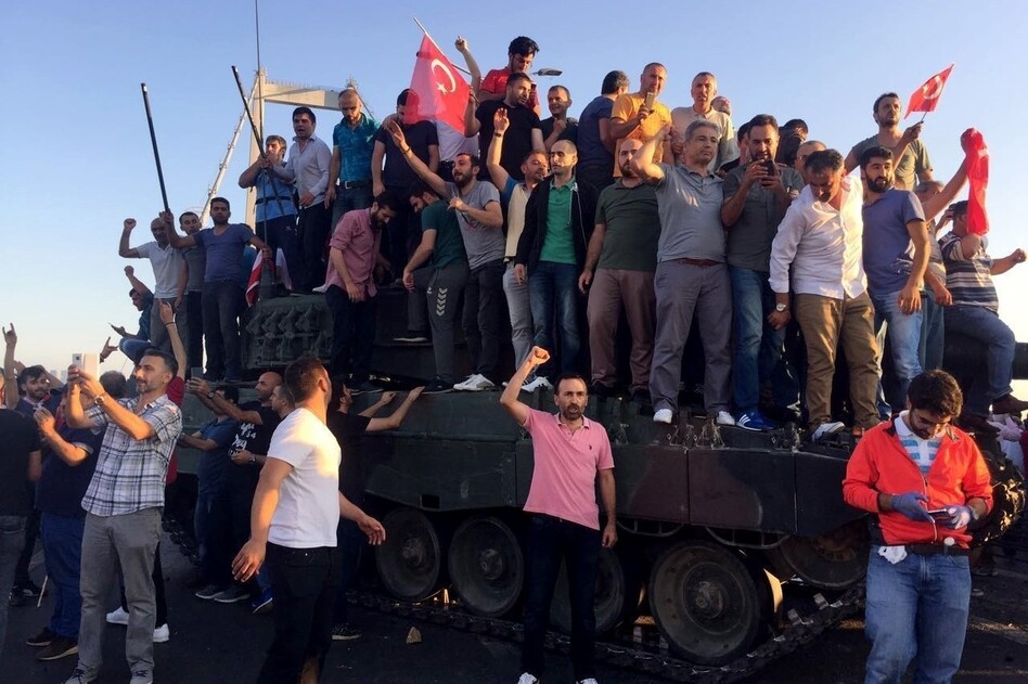 People climb on tanks after soldiers occupying Bosphorus Bridge surrendered in Istanbul, Turkey on Saturday. (Selami Kucukoglu/Anadolu Agency/Getty Images)