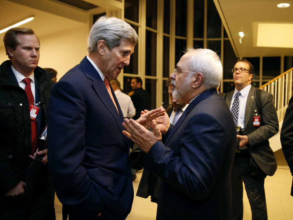 Secretary of State John Kerry talks with Iranian Foreign Minister Mohammad Javad Zarif in Vienna on Jan. 16, after the International Atomic Energy Agency verified that Iran met all conditions under the nuclear deal. The accord is now 1-year-old. Iran is seen as abiding by requirements of the deal, but its relations with the U.S. and other rivals have not improved on other fronts. (Kevin Lamarque/AP)