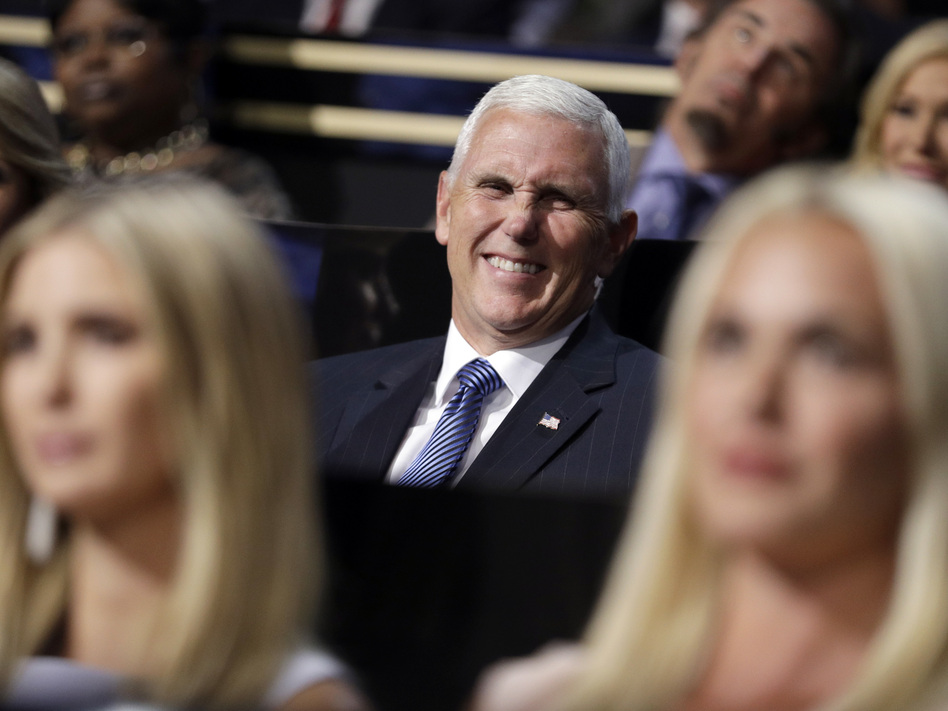 Vice presidential nominee Gov. Mike Pence of Indiana smiles as he sits during the second day session of the Republican National Convention in Cleveland on Tuesday. (John Locher/AP)