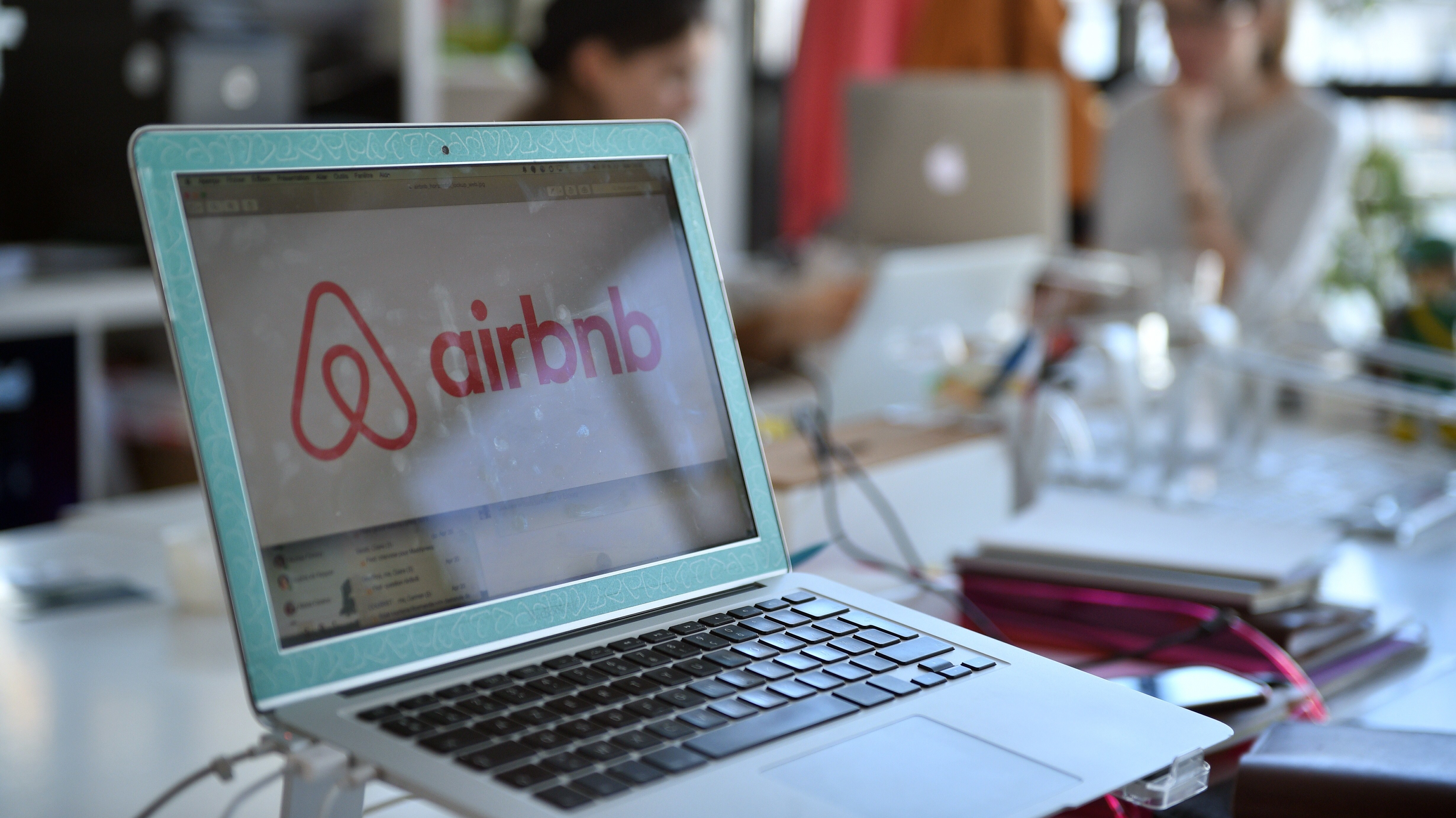 The logo of online lodging service Airbnb is shown on a screen in the Airbnb offices in Paris in 2015. (AFP/Getty Images)
