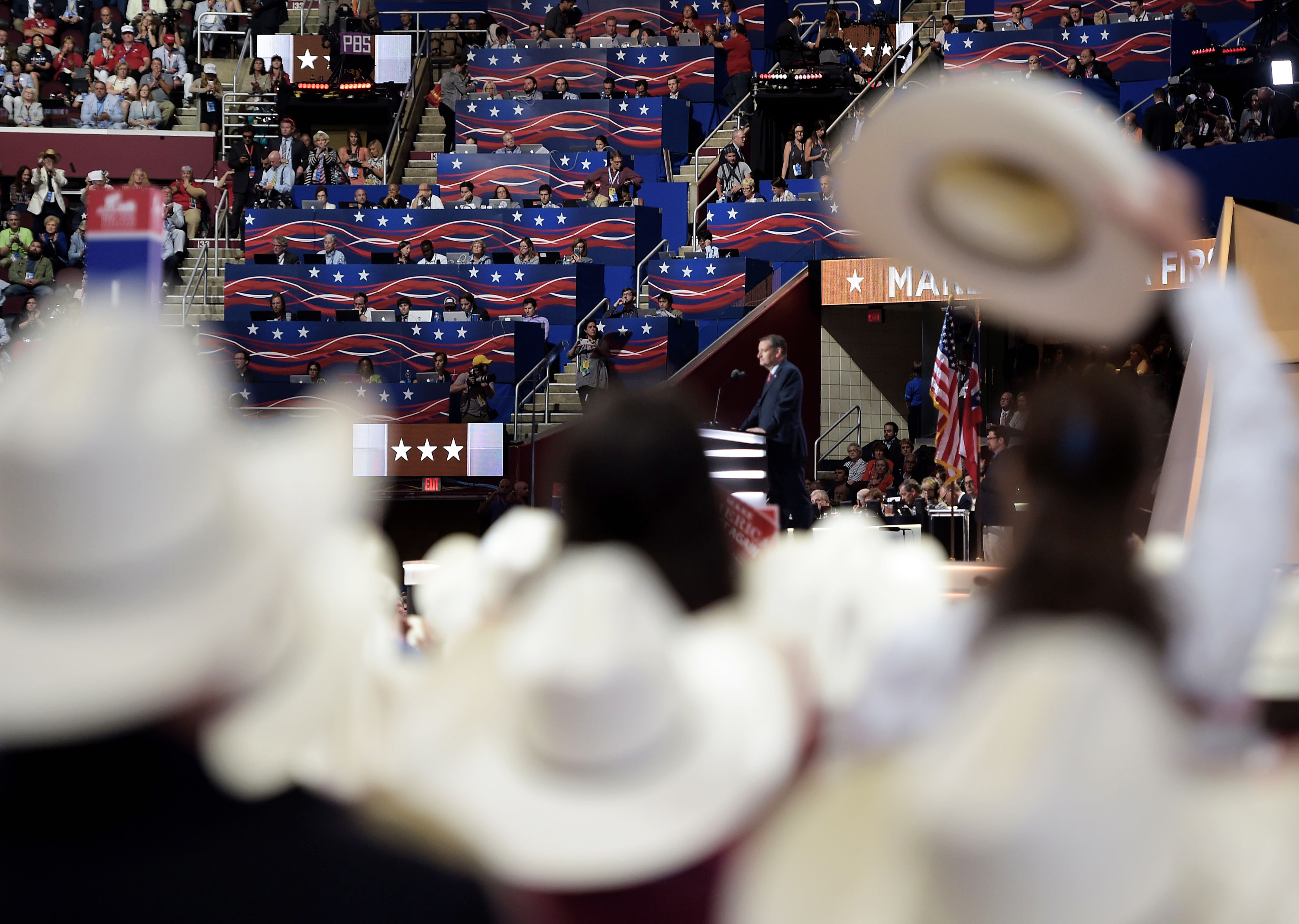 Delegates from Texas listen as Texas senator and former Republican presidential candidate Ted Cruz addresses Wednesday evening's session of the Republican National Convention in Cleveland.