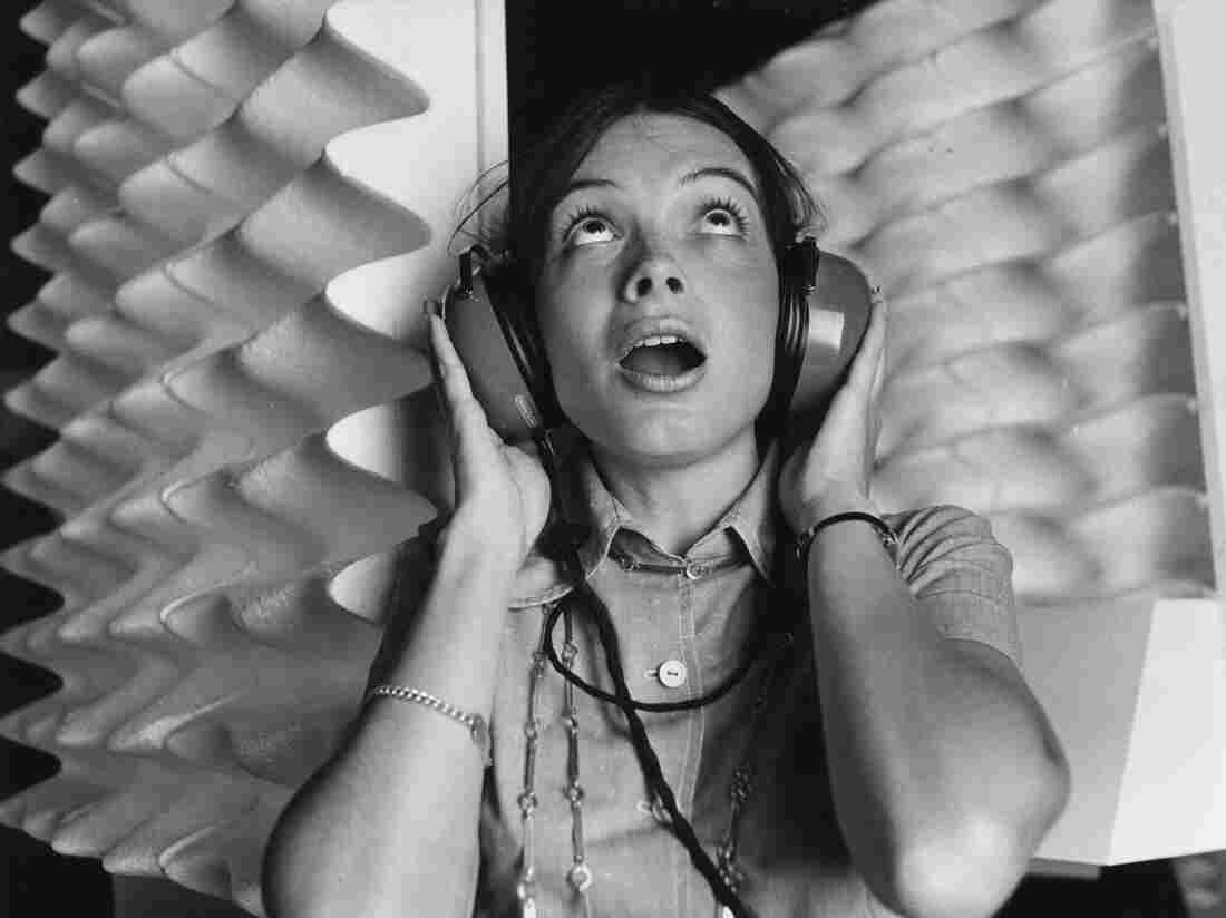 A woman wearing headphones in 1971