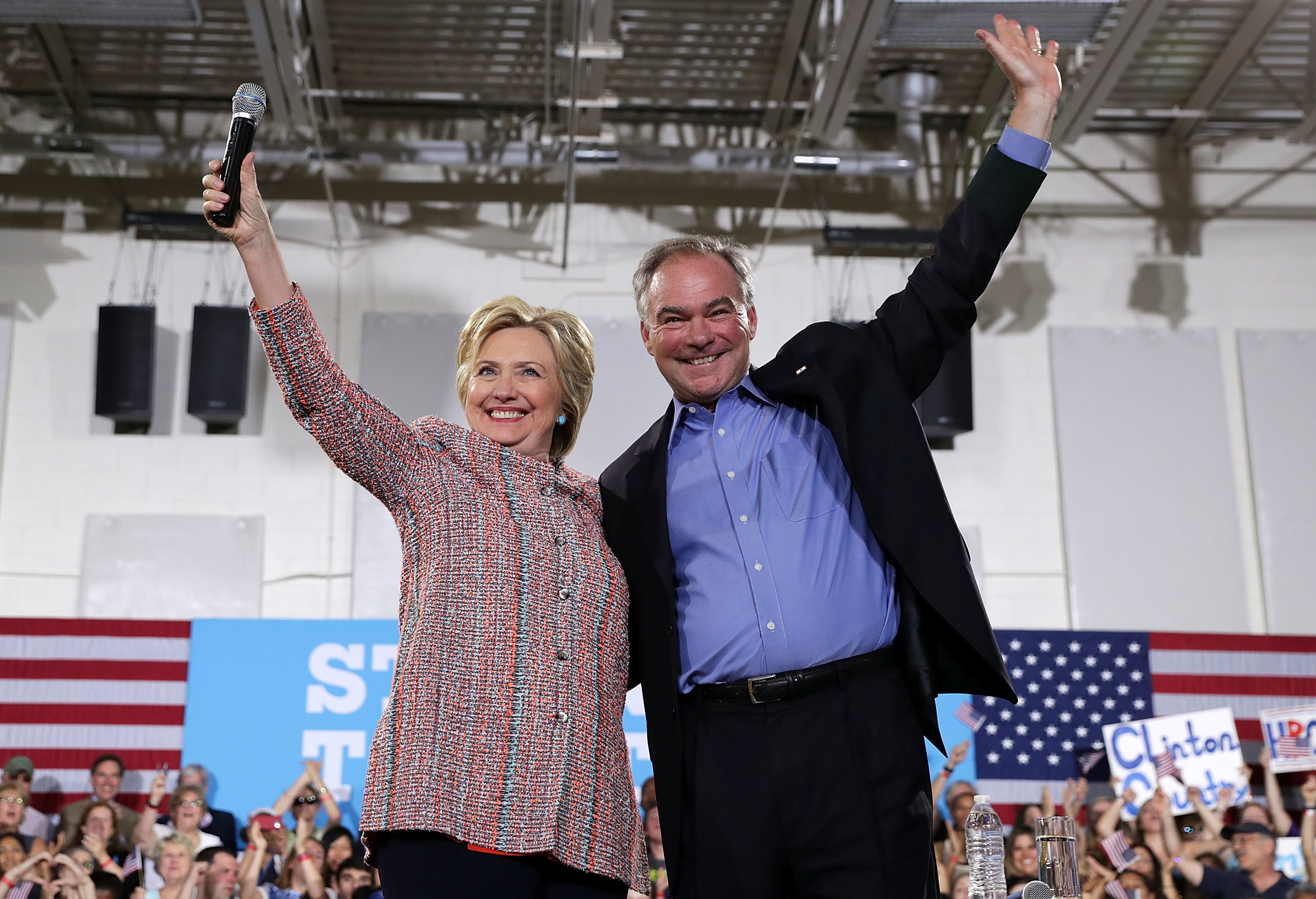 Democratic presidential candidate Hillary Clinton and Sen. Tim Kaine of Virginia greet the crowd during a campaign event on July 14 in Annandale, Va. (Getty Images)