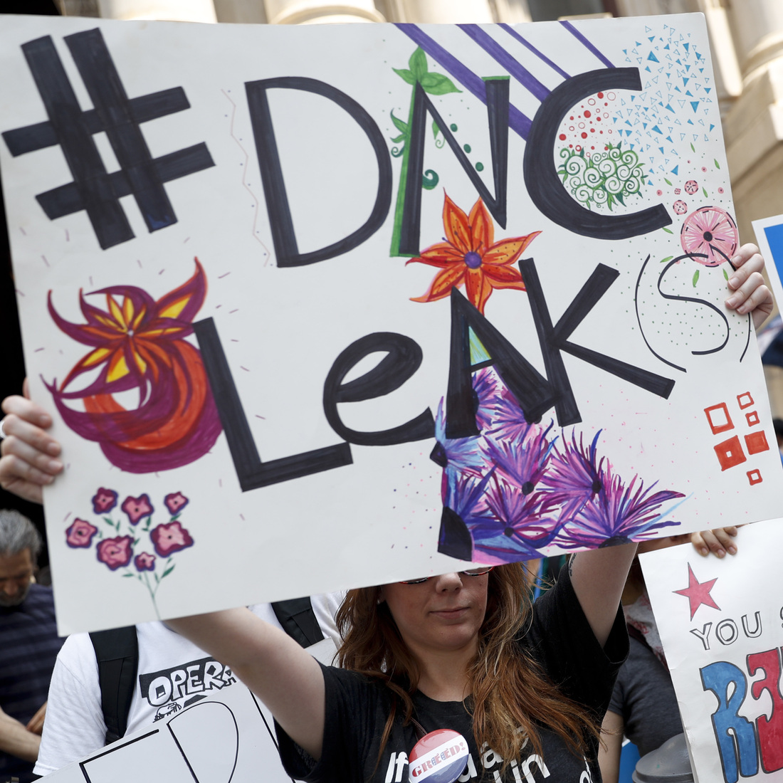 Demonstrators held signs outside the Democratic National Convention on Monday in Philadelphia. On Sunday, Debbie Wasserman Schultz, announced she would step down as DNC chairwoman at the end of the party's convention, after thousands of internal DNC emails were posted by the website Wikileaks. Demonstrators held signs outside the Democratic National Convention on Monday in Philadelphia. On Sunday, Debbie Wasserman Schultz, announced she would step down as DNC chairwoman at the end of the party's convention, after thousands of internal DNC emails were posted by the website Wikileaks.