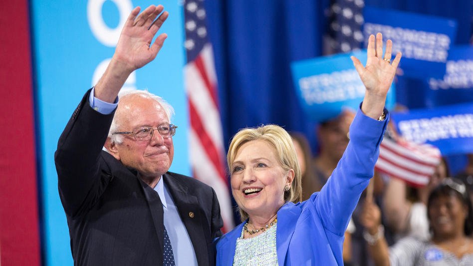 Presumptive Democratic presidential candidate Hillary Clinton and Bernie Sanders wave after speaking at a rally in Portsmouth, N.H. earlier this month. (AFP/AFP/Getty Images)