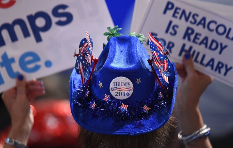 A Hillary Clinton supporter holds up signs on Monday evening.