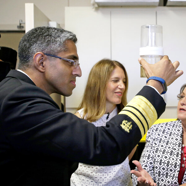 Surgeon General Vivek Murthy looks at a sample of mosquitoes in Orlando, Fla., on Monday. With him is Department of Health and Human Services Secretary Sylvia Burwell and Orange County Mayor Teresa Jacobs.