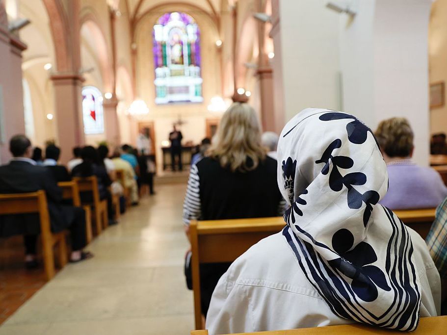 A Muslim faithful woman sits as she attends a Mass in tribute to priest Jacques Hamel at the Saint-Leu Saint-Gilles Bagnolet's Church, near Paris on Sunday.