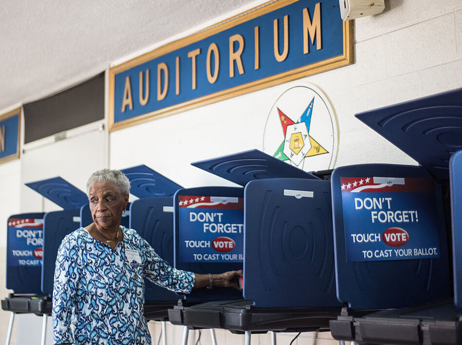 A poll worker prepares a voting machine before the South Carolina primary. The recent hacking of the Democratic Party databases has raised questions about potential issues with voting systems. (Sean Rayford/Getty Images)