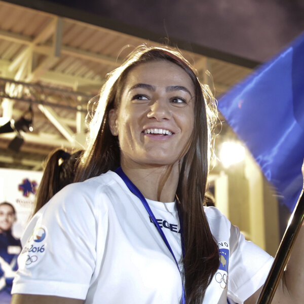 Kosovo's Malinda Kelmendi, who competes in judo, waves the country's flag in the capital city Pristina on July 29. Kosovo, which declared independence in 2008, is sending eight athletes to its first Olympic Games.