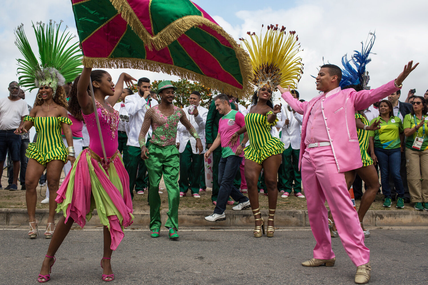 Dancers from the Mangueira samba school perform in the street Thursday while waiting for the arrival of the Olympic flame ahead of the games, which open Friday in Rio de Janeiro. The flame will be carried through the streets of Rio to Maracana Stadium for Friday night's opening ceremony.