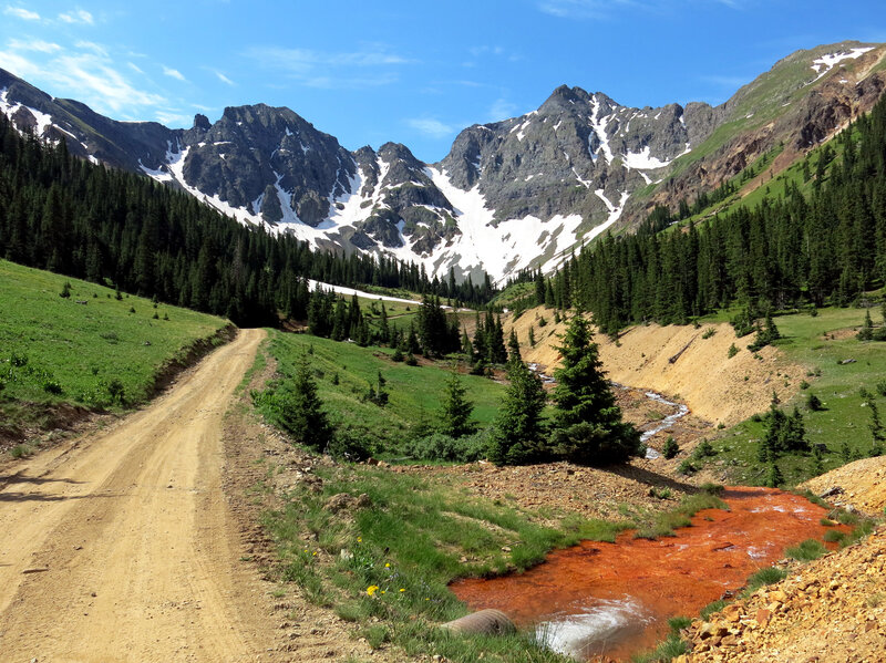 Orange sediment laced with heavy metals is visible in the path of water coming out of the Natalie/Occidental Mine in southwestern Colorado. This mine is one of dozens on a proposed Superfund listing pending with the EPA. Several mines in the area have been leaching the tainted water for years — well before the Gold King Mine spill.