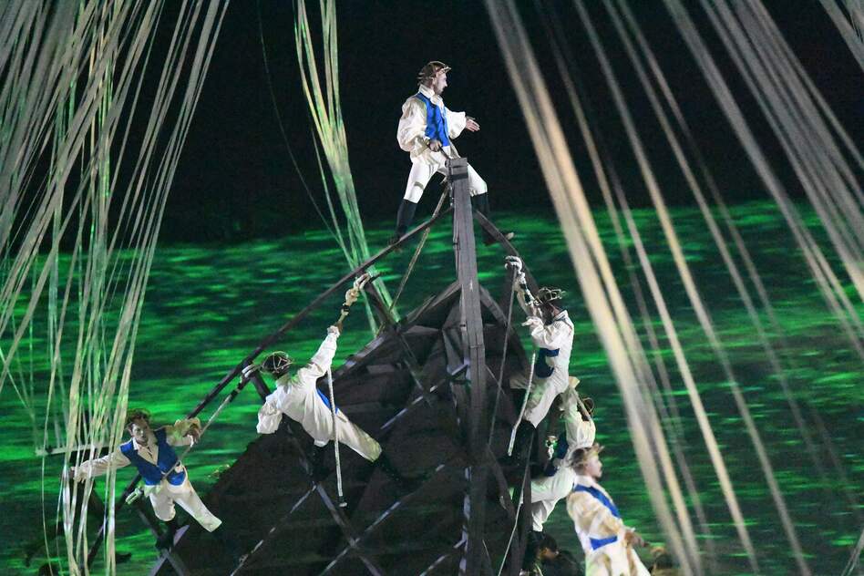 Acrobats simulate the arrival of Europeans in ships, three mechanical Caravels, where they meet indigenous people. (Getty Images)