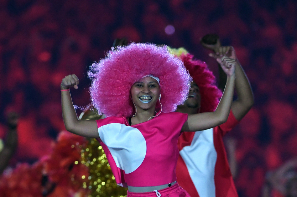 The music pumps and the colors explode on the stage as dancers move. (AFP/Getty Images)