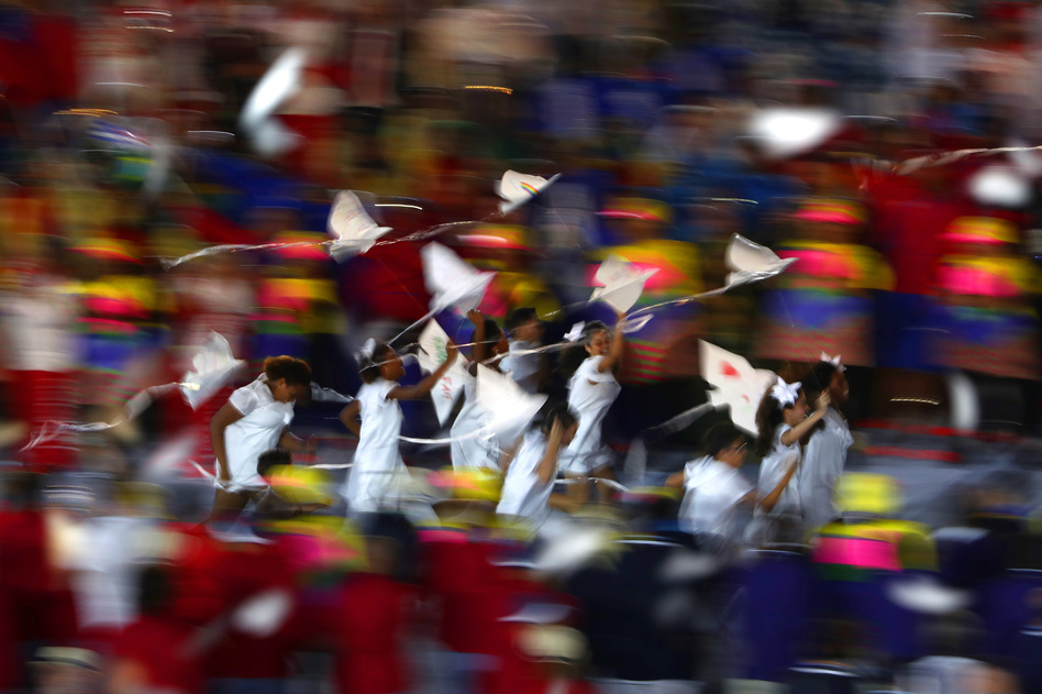 A group of children run onto the stage carrying small dove kites with Kipchoge Keino, 72 — a former Olympian who won two gold medals and is now the chairman of the Kenyan Olympic Committee. Keino is the first-ever winner of the Olympic Laurel award. (Getty Images)