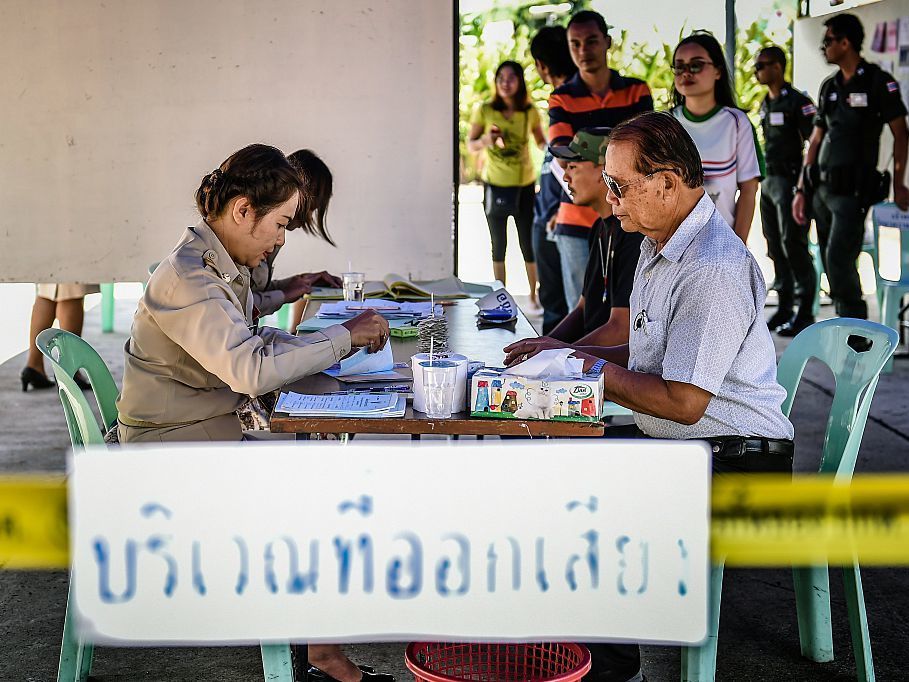 People register to vote at a polling station before casting their ballots in the constitutional referendum in Thailand's northeastern province of Buriram on Sunday.