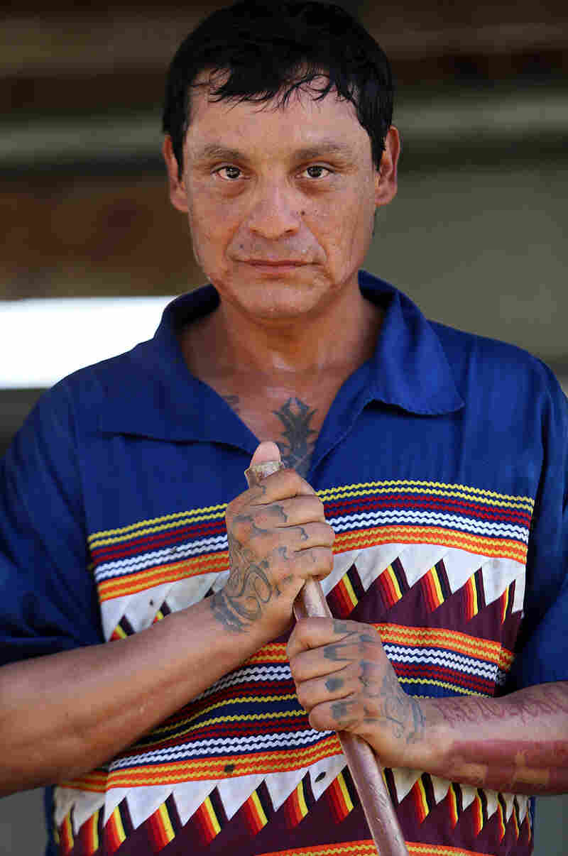 Joe Osceola, 40, wears a traditional Seminole Patchwork shirt while herding cattle at the weigh station at Brighton.