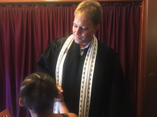 The Rev. Seth Kaper-Dale shakes hands after a service at the Reformed Church of Highland Park.