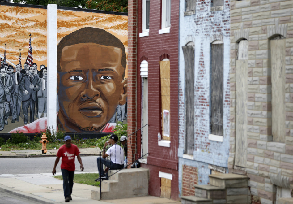 People walk by a mural depicting Freddie Gray in Baltimore on June 23, at the intersection where Gray was arrested in 2015. (Patrick Semansky/AP)