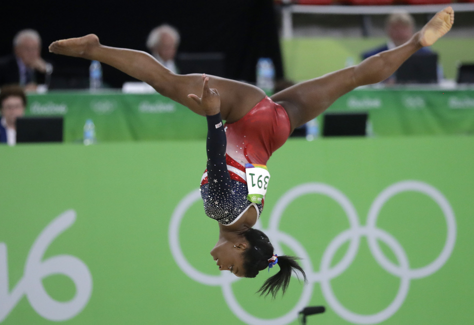Simone Biles of the U.S. performs on the floor during the women's team final on Tuesday. Biles led the American squad to a runaway victory as the U.S. successfully defended the gold they won four years ago. (Julio Cortez/AP)