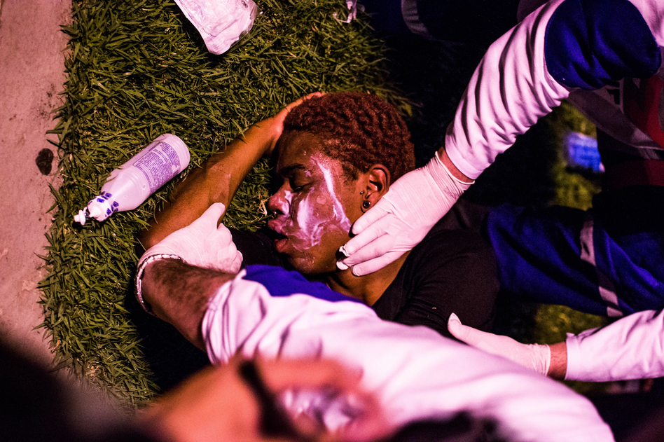 A protester receives medical attention after tear gas was used during a demonstration in Rio de Janeiro on Aug. 5.