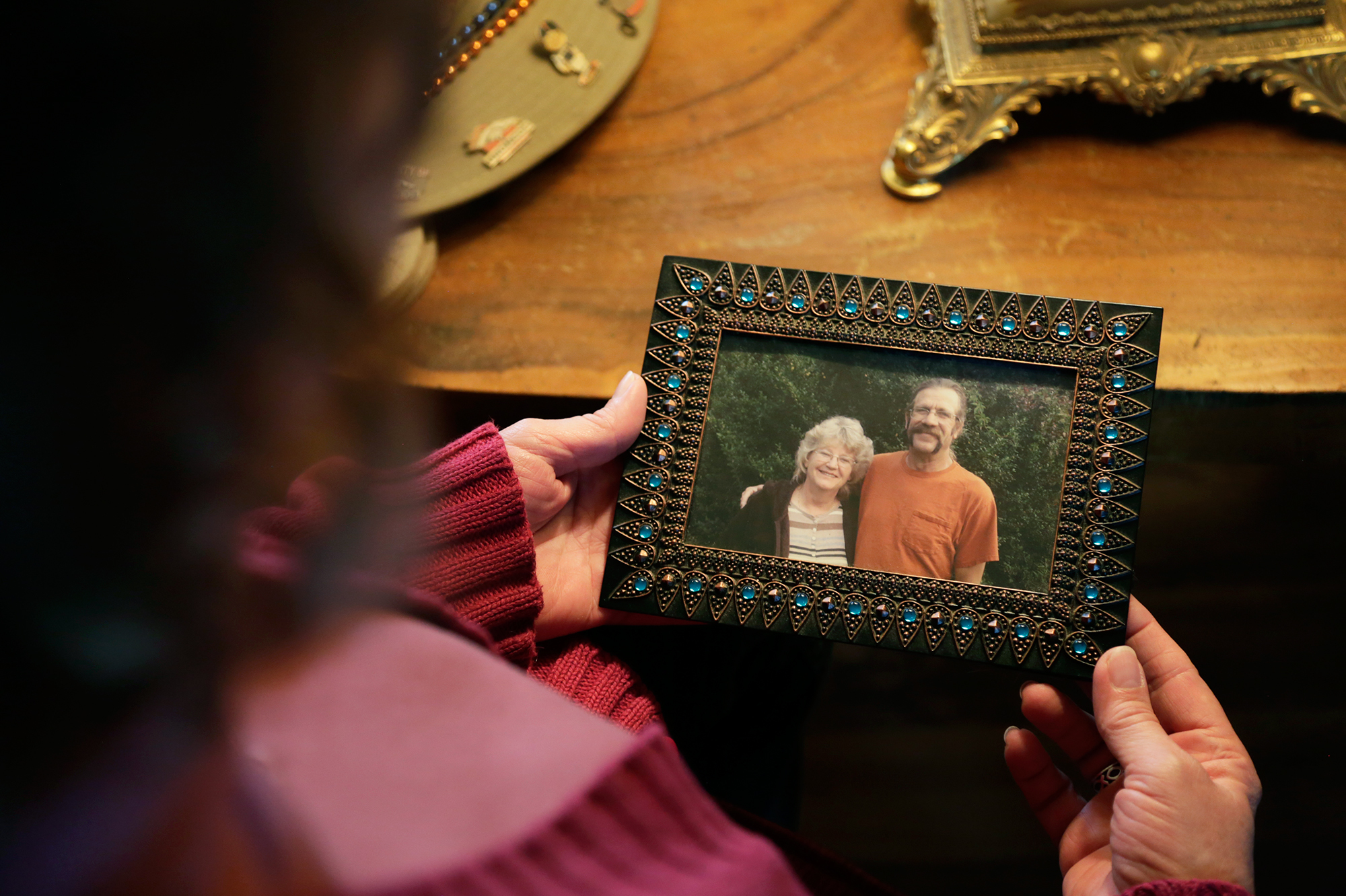 Greta Horner holds a photo of her and her husband Ed taken a few months before he died. (Rocky Mountain PBS for Harvest Public Media)