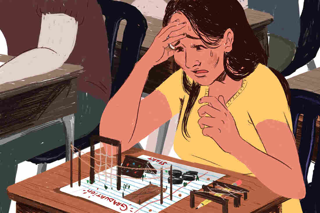 Native American college student sitting at desk staring at all the obstacles on her way to graduating.