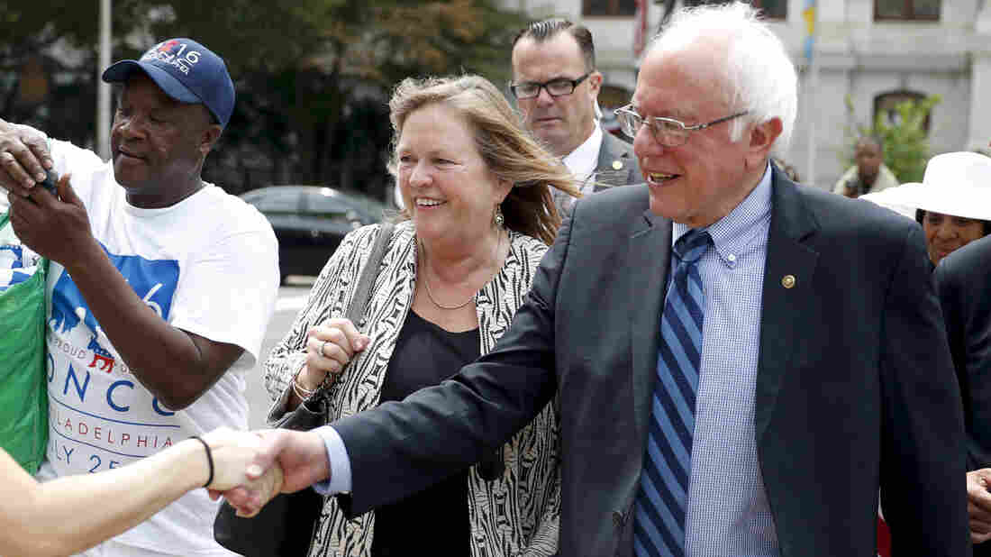 Sen. Bernie Sanders, I-Vt., right, shakes hands with a supporter in downtown Philadelphia during the final day of the Democratic National Convention. (AP Photo/John Minchillo)