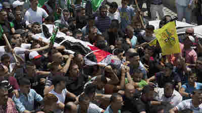 Mourners carry the body of Palestinian Laith al-Khaldi during his funeral procession at the Jalazoun refugee camp, near the West Bank city of Ramallah, on Aug. 1, 2015. An Israeli soldier shot Khaldi after he had been throwing rocks at a military post. This was during a relatively calm period, although almost two dozen Palestinians were killed during the first half of the year.