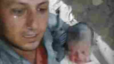 Syrian Civil Defense Force rescuer Khaled Omar Harrah after pulling a baby from a destroyed home in Aleppo. The moment was caught on video and gained international attention.